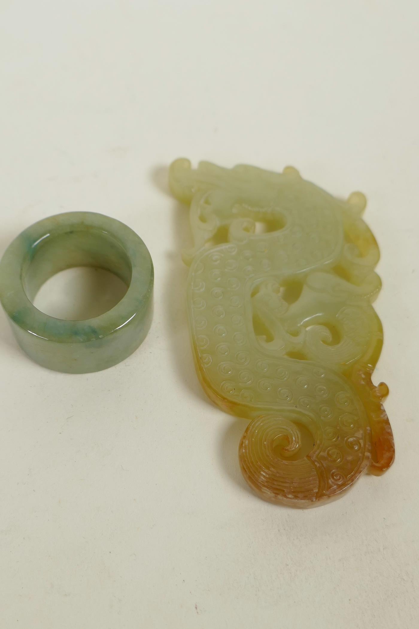 A Chinese green jade archer's ring and a carved jade dragon pendant, largest 3"