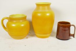 A yellow glazed Bretby Pottery baluster vase with ring turned neck, 8¾" high, together with a