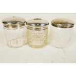 Three silver lidded glass dressing table jars, silver weight 29.9 grams