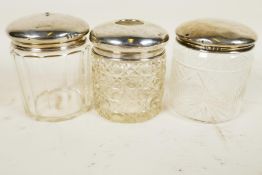 Three silver lidded glass dressing table jars, silver weight 29.9 grams