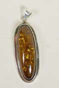 A silver mounted faux amber pendant, 2½" long