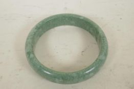 A Chinese green hardstone bangle, 3" diameter