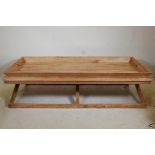 A tray top wooden garden table, 67" x 30" x 18"