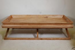 A tray top wooden garden table, 67" x 30" x 18"