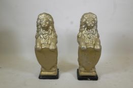 A pair of gilt moulded concrete garden lions, 31" high