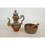 A Tibetan brass singing bowl, and an Oriental copper and white metal kettle with dragon and kylin