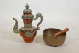 A Tibetan brass singing bowl, and an Oriental copper and white metal kettle with dragon and kylin