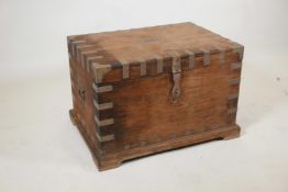 An Indian teak blanket box with brass mounts and shaped plinth base, 27" x 19" x 18"