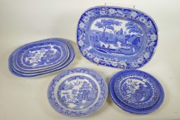 A C19th blue and white meat plate with a boatman on a river, within a wild rose border, possibly