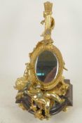 A gilt bronze table mirror in the form of a lute with cherubs, on a marble base, 12" high