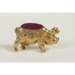 A miniature brass pincushion in the form of a pig, 1½" long