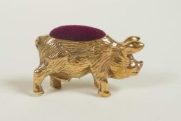 A miniature brass pincushion in the form of a pig, 1½" long