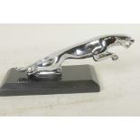 A desk top chrome plated paperweight in the form of a Jaguar car mascot, 7½" long