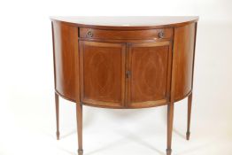 A C19th demilune inlaid mahogany side cabinet with single frieze drawer over central cupboard