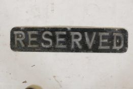 A vintage aluminium 'Reserved' sign, 23" x 5"