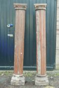 Architectural salvage: A pair of Indian carved and painted teak reeded columns, with carved