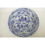 A Chinese blue and white porcelain charger decorated with figures in a garden, 18½" diameter