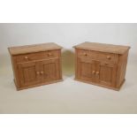 A pair of pine two door bedside cabinets with a single drawer, 27" x 14" x 20"high