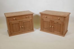 A pair of pine two door bedside cabinets with a single drawer, 27" x 14" x 20"high