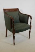 An Empire style mahogany armchair with carved back rail, reeded arms and tapering supports
