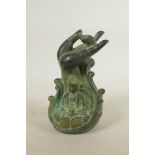 A Chinese filled bronze figure of Buddha seated beneath a meditative hand, seal mark to base, 7½"