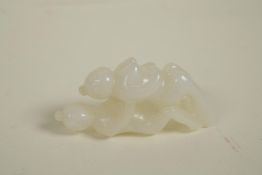 A Japanese carved white jade netsuke of erotic form, 2"