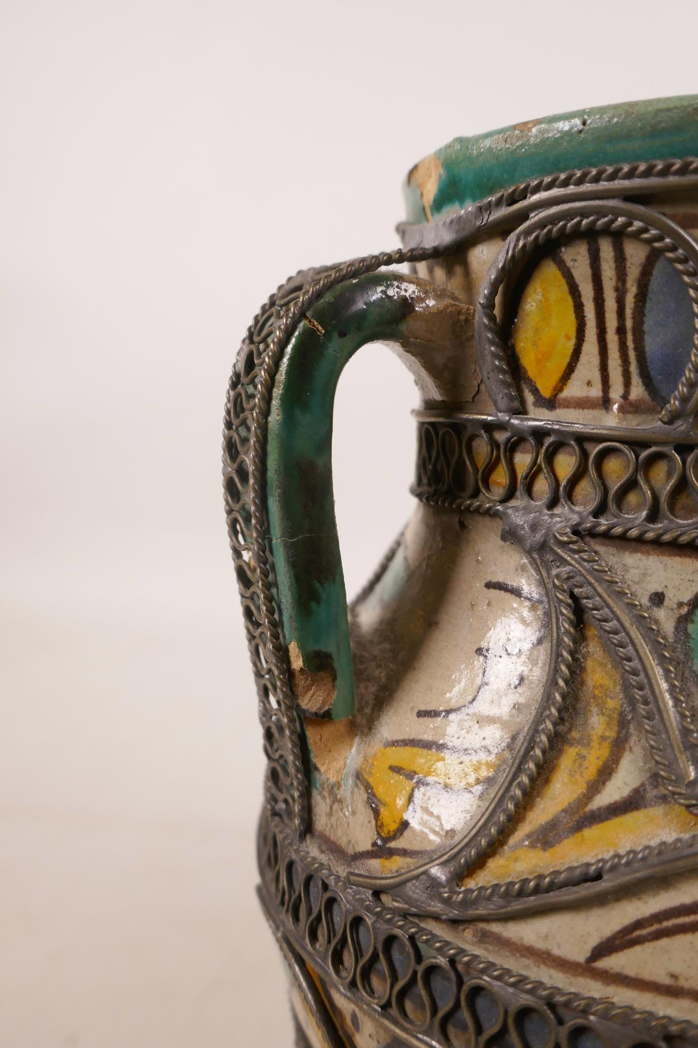 A North African pottery ewer with metal mounts, A/F repair to rim, 7½" high - Image 5 of 7