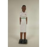 An African carved and painted wood figure of a healthworker, 23" high