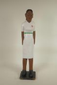 An African carved and painted wood figure of a healthworker, 23" high