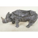 A cold painted cast bronze inkwell in the form of a rhinoceros, 6½" long