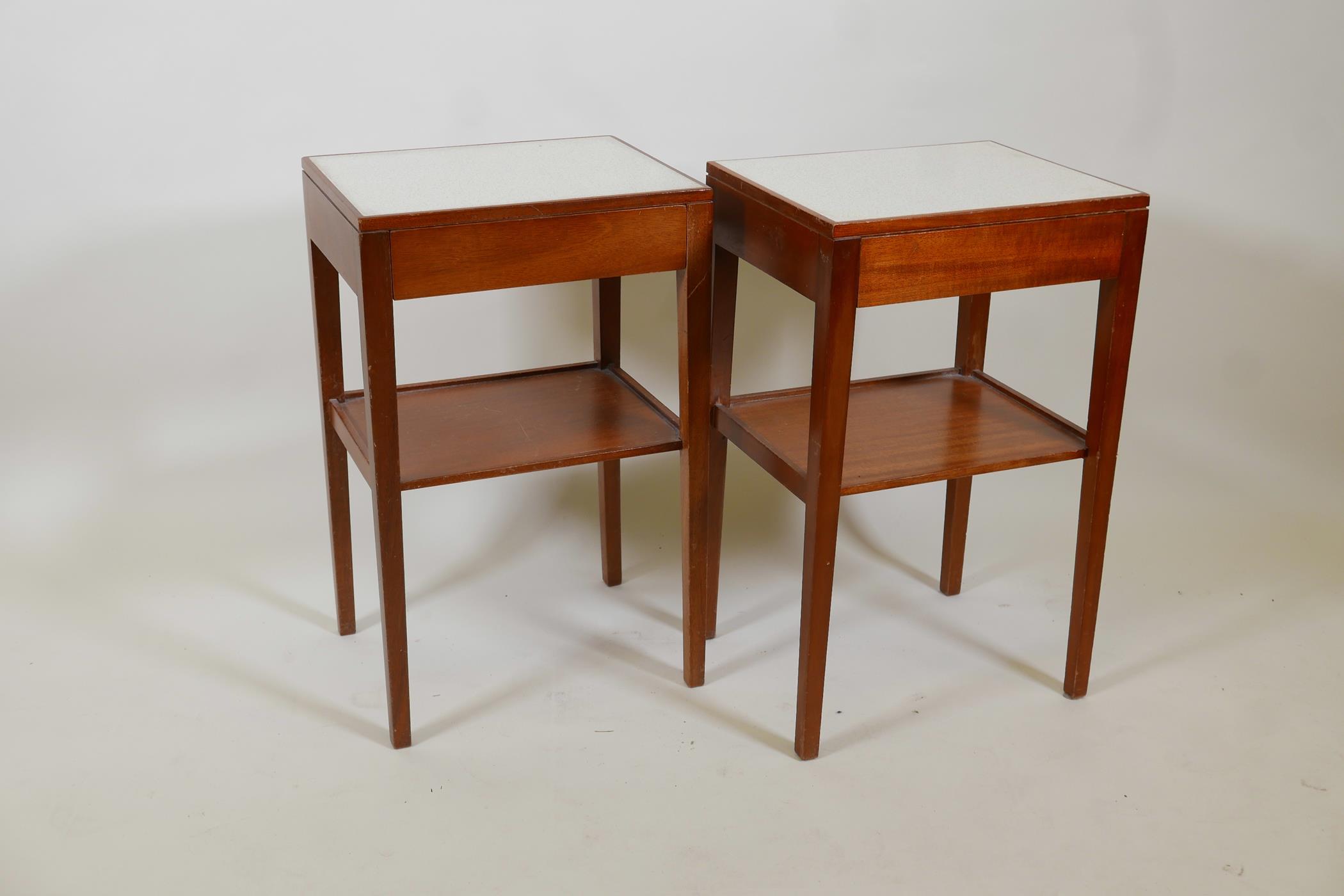 A pair of mid century Remploy teak bedside tables with a formica top, single drawer and undertier,