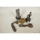 A collection of curios, a Boy Scouts knife, a miniature microscope, a Bully Beef tin opener, an