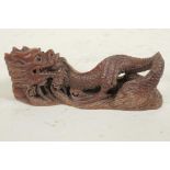 A Japanese carved hardwood okimono of a dragon, 4½" long