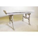 A C19th painted cast iron bench, with wood top, the ends with entwined serpents and oak branches,