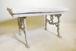 A C19th painted cast iron bench, with wood top, the ends with entwined serpents and oak branches,