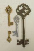 Four antique style keys in various metals, 11" largest