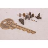 A quantity of hallmarked silver and other thimbles, and brass key and eastern bronze stamp