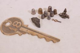 A quantity of hallmarked silver and other thimbles, and brass key and eastern bronze stamp