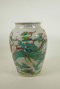 A Chinese polychrome pottery jar decorated with a dragon, 6 character mark to lip, 12" high