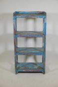 An Indian hardwood four tier open shelf with distressed paintwork, 23" x 13" x 46"