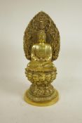 A Chinese polished brass Buddha seated on a lotus throne, 4 character mark to base, 15" high