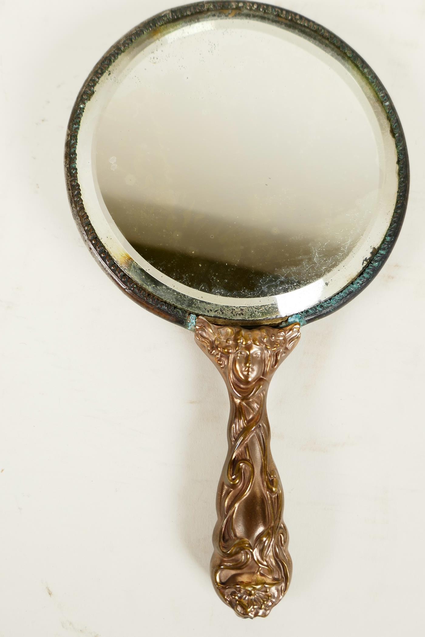 A C19th Art Nouveau bronze hand mirror embossed with scrolls and faces, and bejewelled glass mirror, - Image 4 of 4