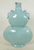 A Chinese pale blue glazed porcelain double gourd vase with embossed decoration of dragons and fish,