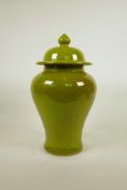 A Chinese lime green crackle glazed porcelain baluster jar and cover, 14" high