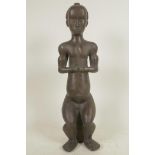 An African bronze figure of a seated man, 14½" high