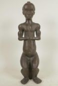 An African bronze figure of a seated man, 14½" high