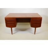 A Danish 1960s teak two sided desk designed by J. Svenstrup for A.P. Møbler, with six drawers to one