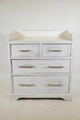 A painted pine chest with a three quarter gallery, two short drawers over two long, steel handles,