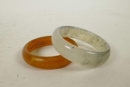 A mottled grey hardstone bangle and another, 3" diameter