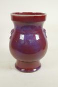 A Chinese Jun ware pottery vase with two mask handles, 10½" high